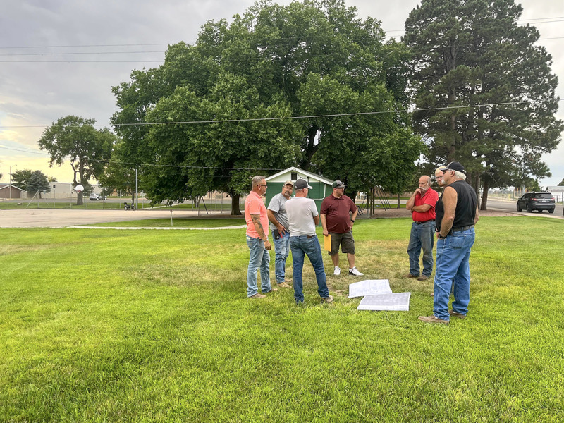 Fleming Mayor Stefan Betley and Town Superintendent Keith Beck discuss Splash Pad plans with Jeff Schiel & local subcontractors.